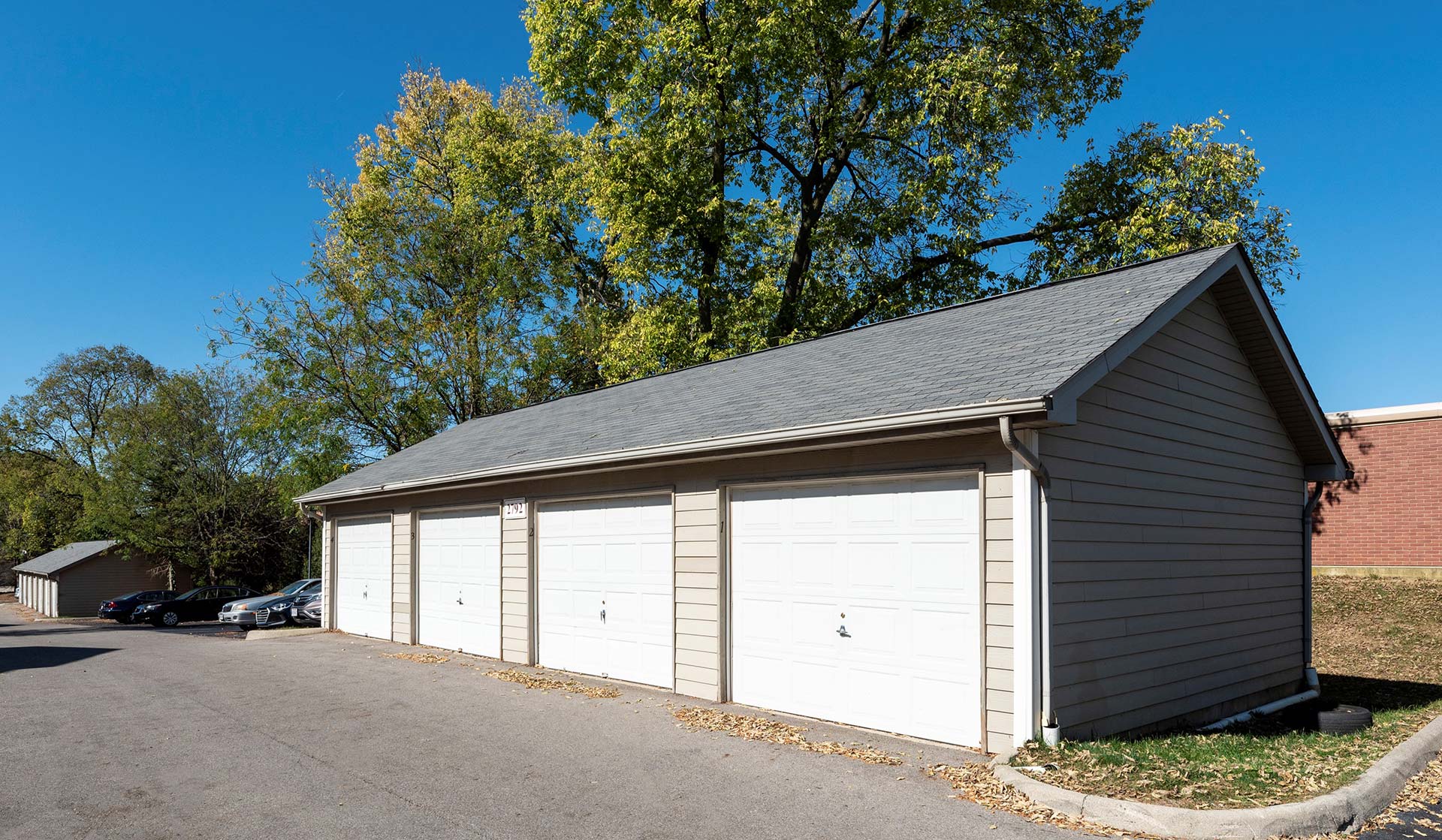 a garage with two garages and a driveway at The Sawmill Park
