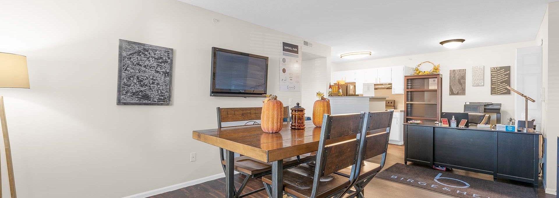 a living room and dining room area with a table and chairs at The Sawmill Park