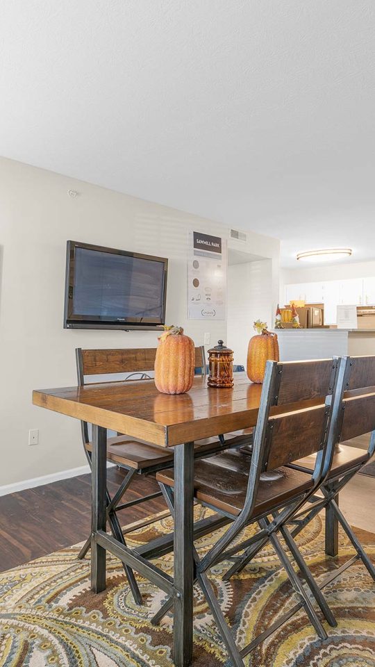 a living room and dining room area with a table and chairs at The Sawmill Park