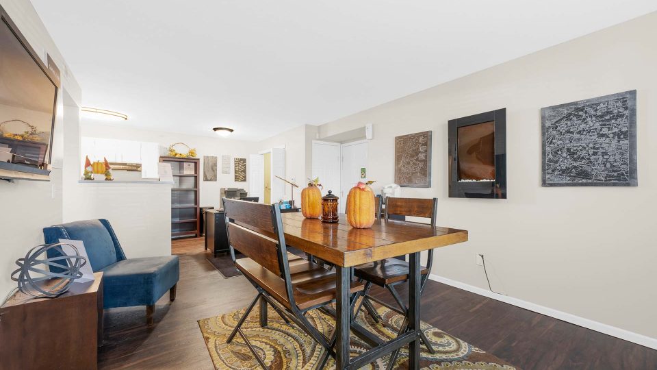 a living room and dining area with a table and chairs at The Sawmill Park